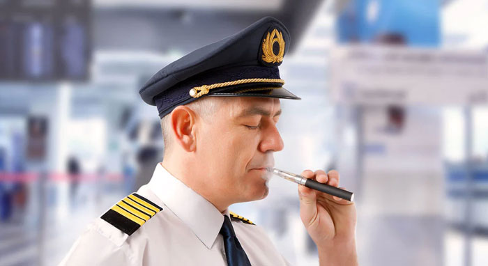 Pilot vaping electronic cigarette in an airport.