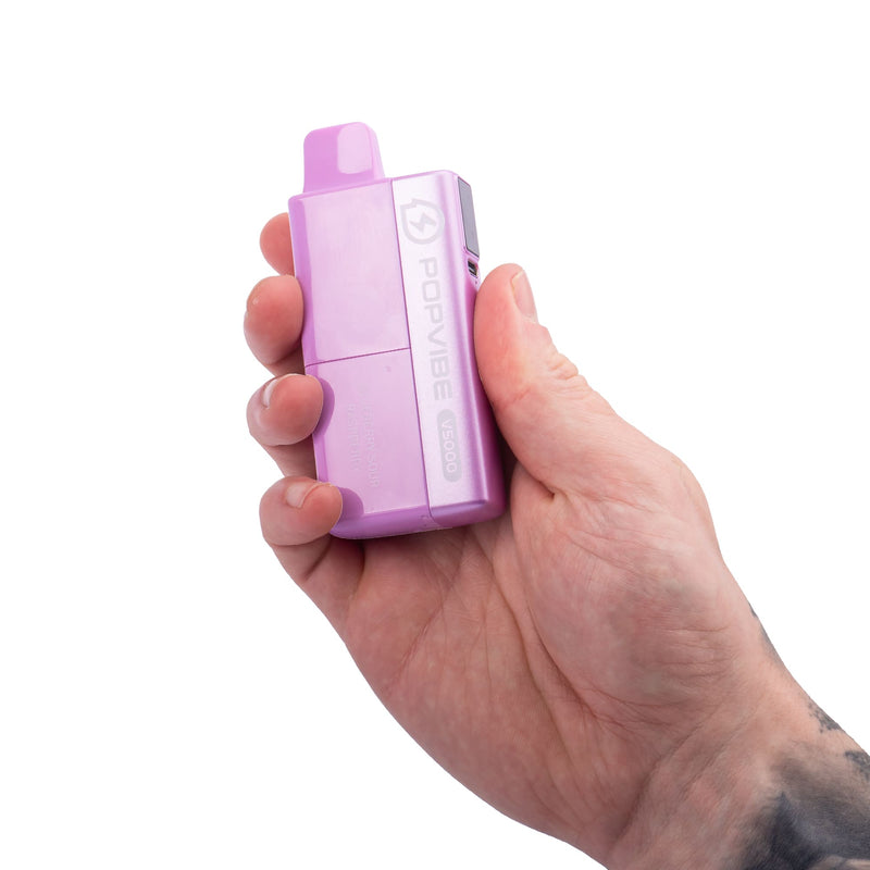 Blueberry Sour Raspberry Geekvape Popvibe disposable vape in hand.