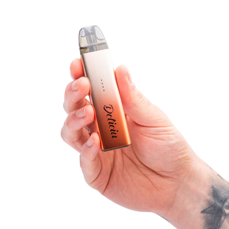 Sunset Orange Deliciu Mate pod kit device in hand.